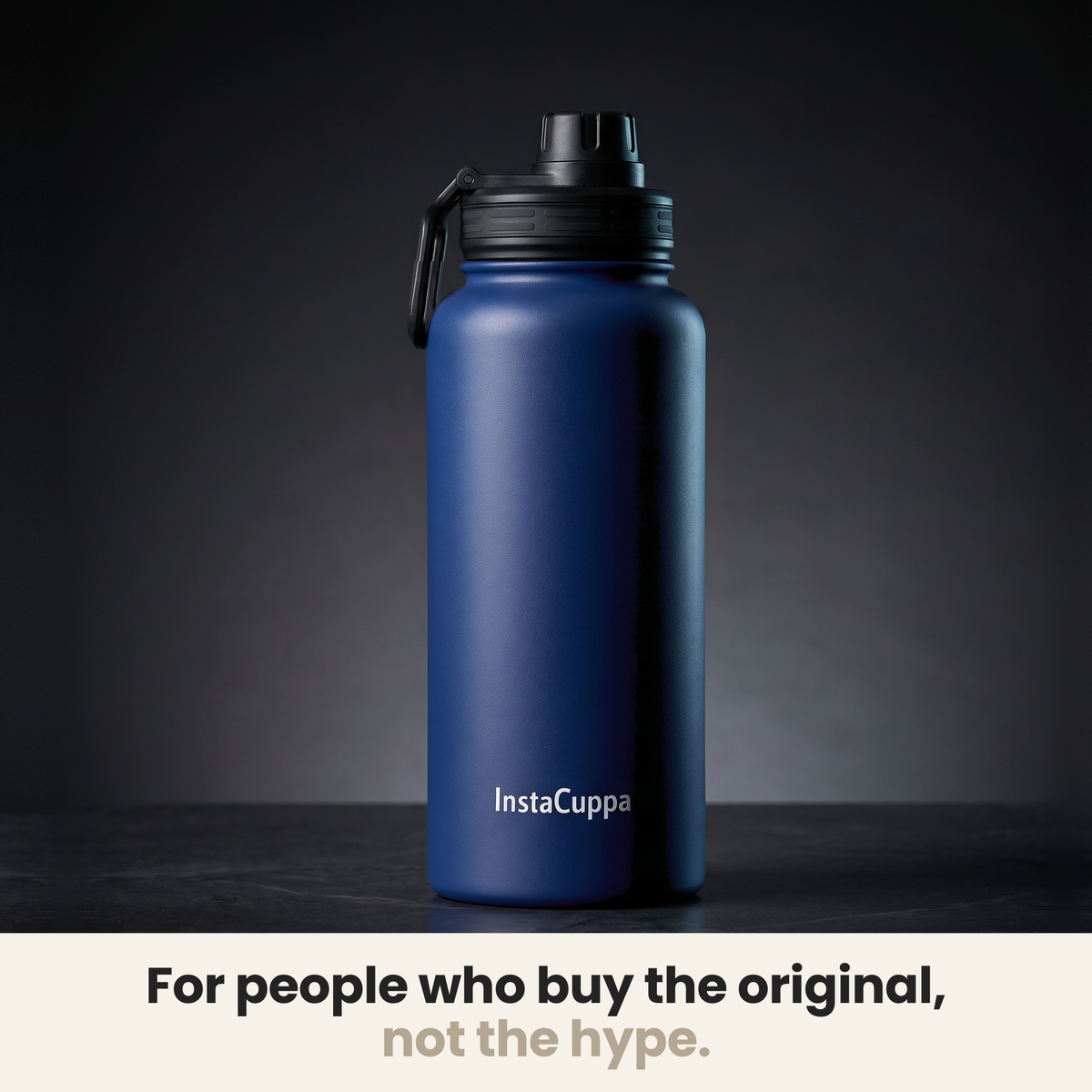 InstaCuppa Insulated Water Bottle 1L (1000 ml) - Navy Blue - bottle spotlit on dark stone, caption: for people who buy the original, not the hype
