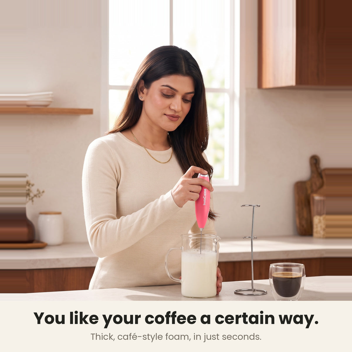 InstaCuppa Milk Frother with Stand - Pink - woman frothing milk for her coffee at home · 4 whisks