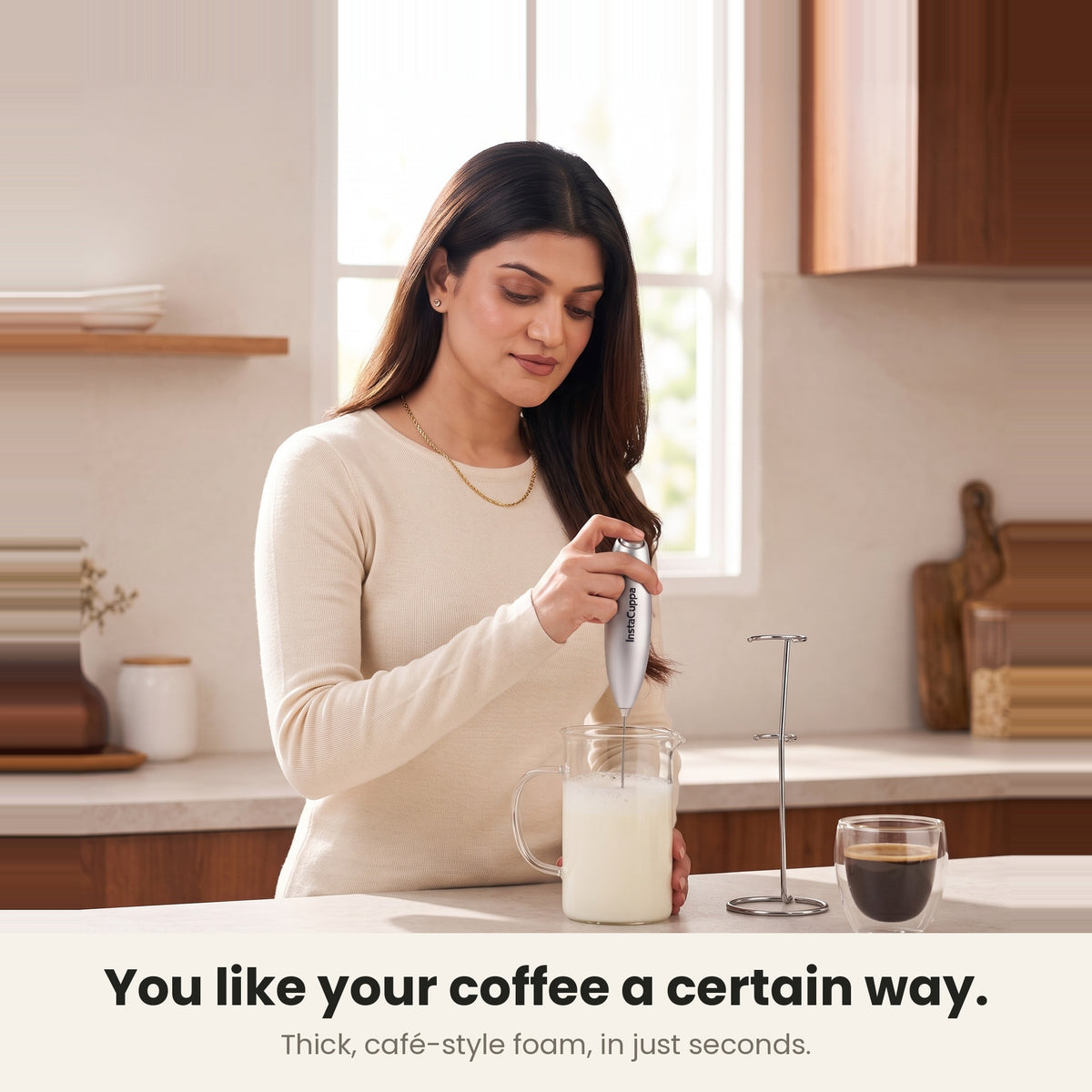 InstaCuppa Milk Frother with Stand - Silver - woman frothing milk for her coffee at home · 4 whisks