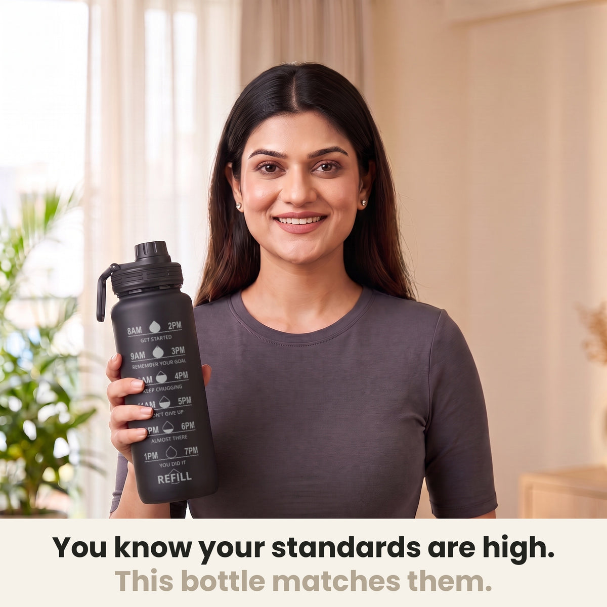 InstaCuppa Motivational Water Bottle 1 Litre - Black - woman holding the sipper bottle at home, made for high standards