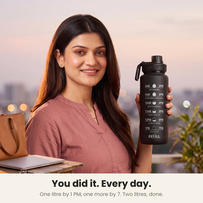 InstaCuppa Motivational Water Bottle 1 Litre - Black - woman at 7 PM with the bottle: 1 litre by 1 PM, 1 more by 7 PM