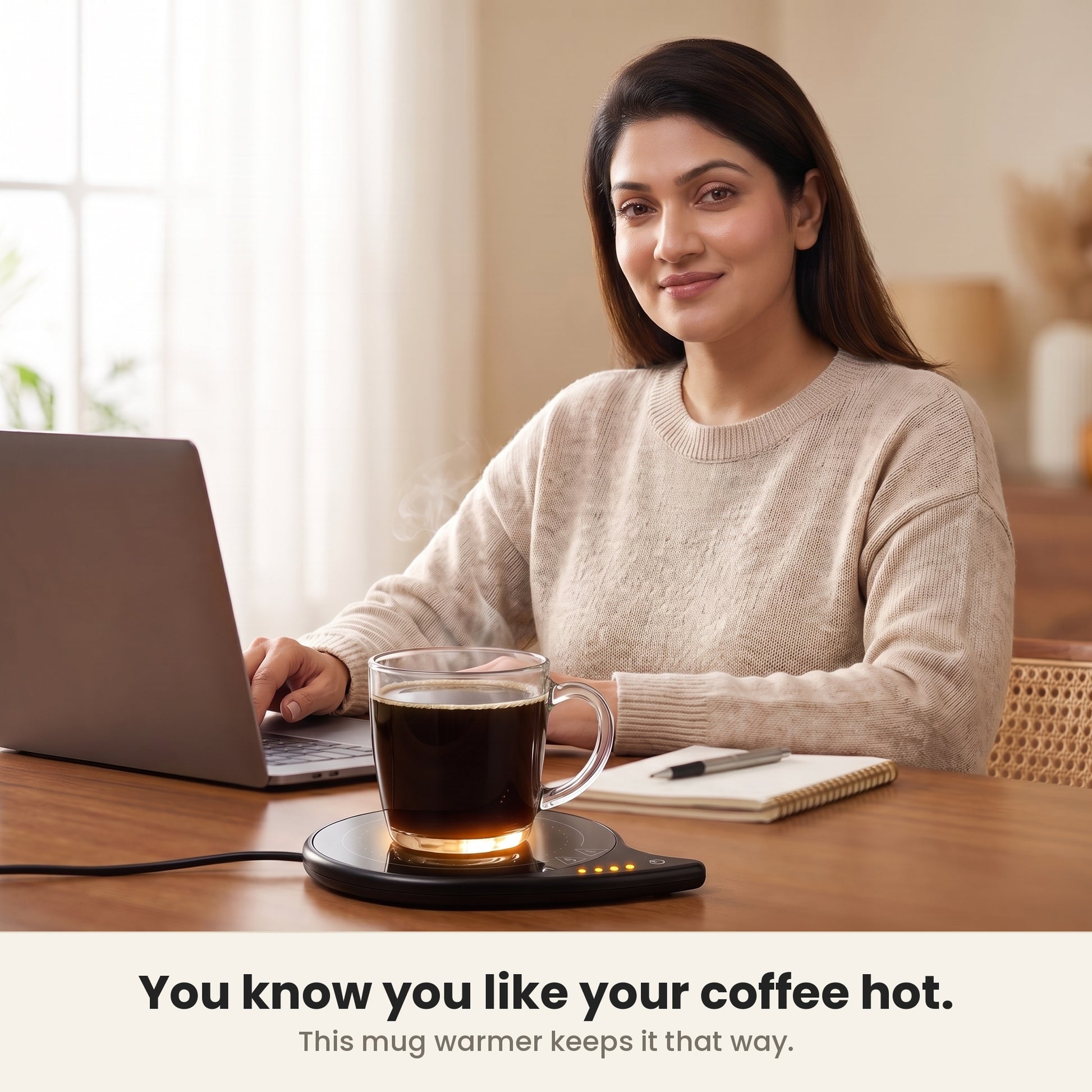 InstaCuppa coffee mug warmer for desk in use at a home office, glass mug hot beside the laptop
