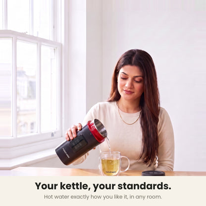 InstaCuppa Portable Electric Kettle 500 ml with Temperature Control - Black - pouring hot water into a glass mug of tea