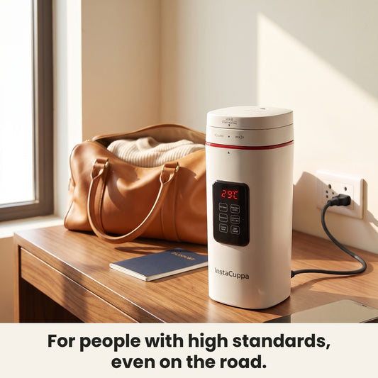 InstaCuppa Electric Kettle With Temperature Control 500 ml - White - on a hotel desk with travel bag, plugged in #color-white