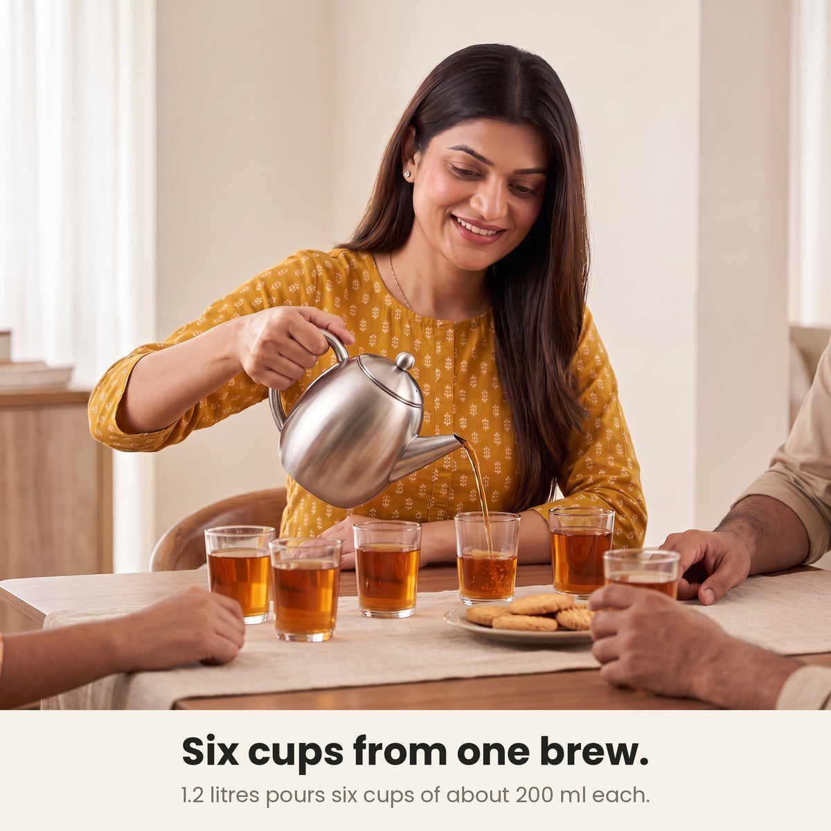 InstaCuppa steel tea pot — pouring six glasses of tea from one 1.2 litre brew at a family table