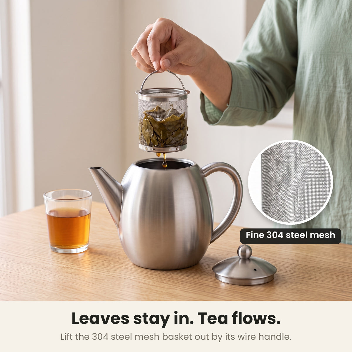 InstaCuppa steel tea pot — lifting the fine 304 steel mesh strainer basket out of the pot, tea leaves inside