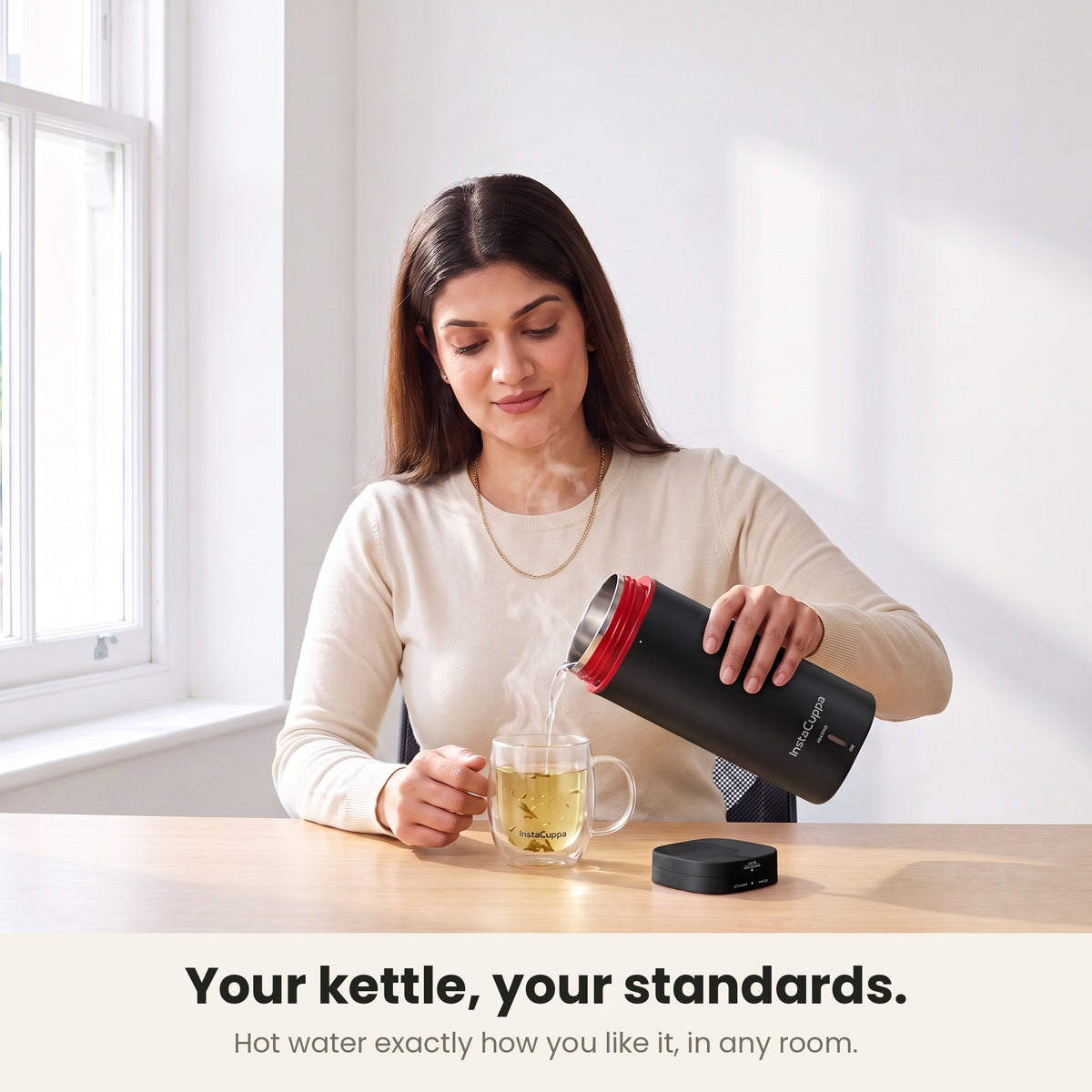 InstaCuppa Portable Electric Kettle 500 ml - Black - pouring hot water into a glass mug of tea