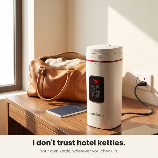 InstaCuppa Portable Electric Kettle 500 ml with Temperature Control - White - on a hotel desk with travel bag, plugged in #color-white